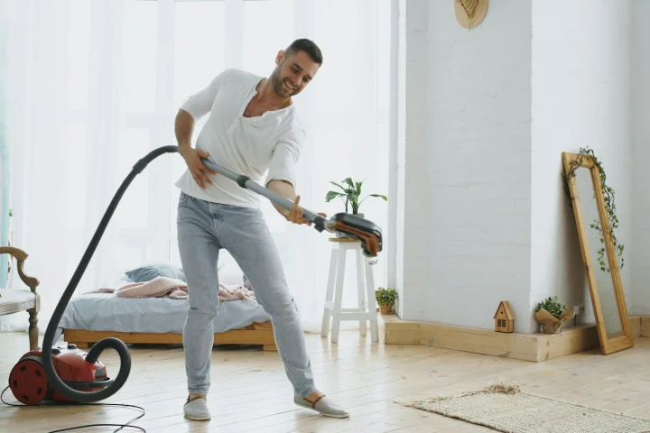 Man vacuuming an apartment floor