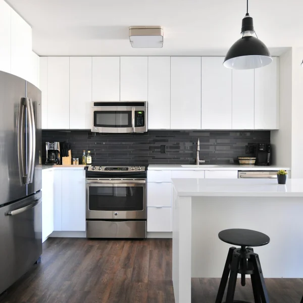 Clean white kitchen with stainless steel appliances
