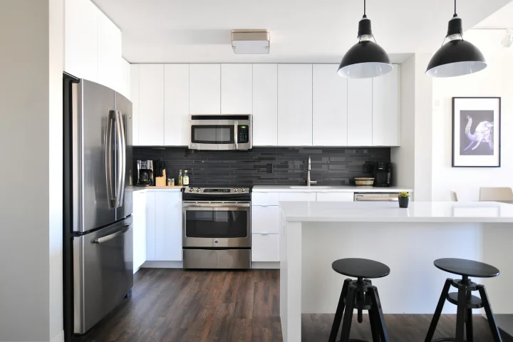 Clean white kitchen with stainless steel appliances