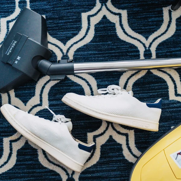 Vacuuming a patterned area rug